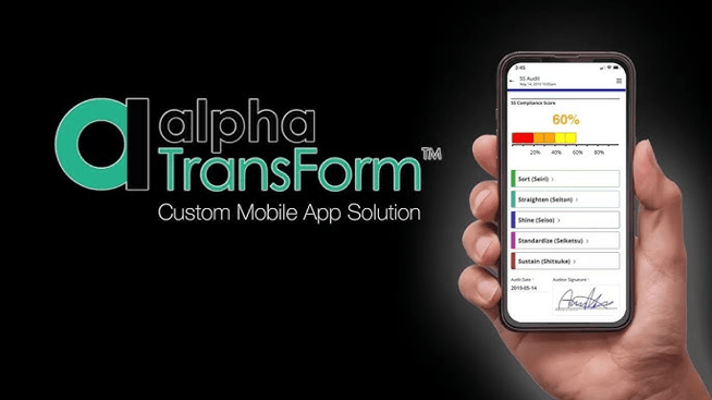 Hand holding a smartphone displaying the Alpha TransForm app with a compliance score, alongside the Alpha TransForm logo.